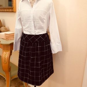 - Navy blue skirt with white stitching.